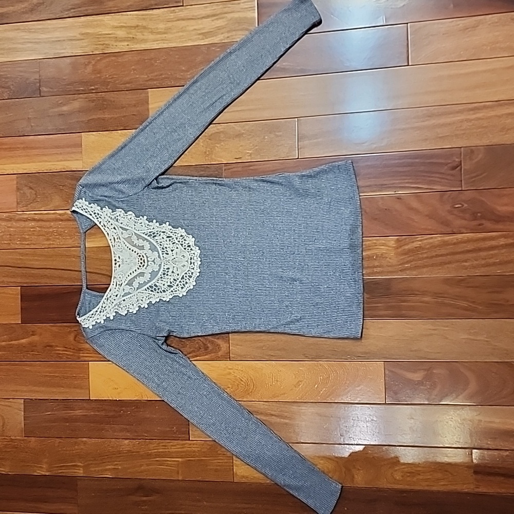 Women's gray ribbed knit long sleeve shirt with lace on front.